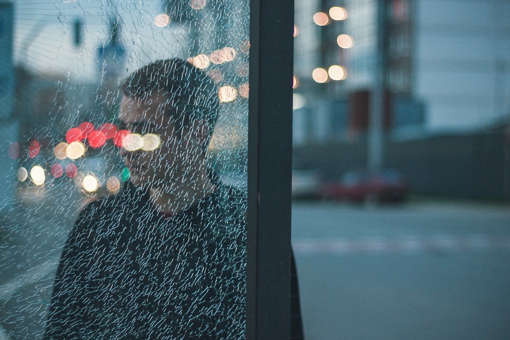 man standing near buildings in bokeh photography