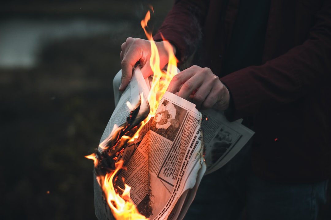 person holding burned paper