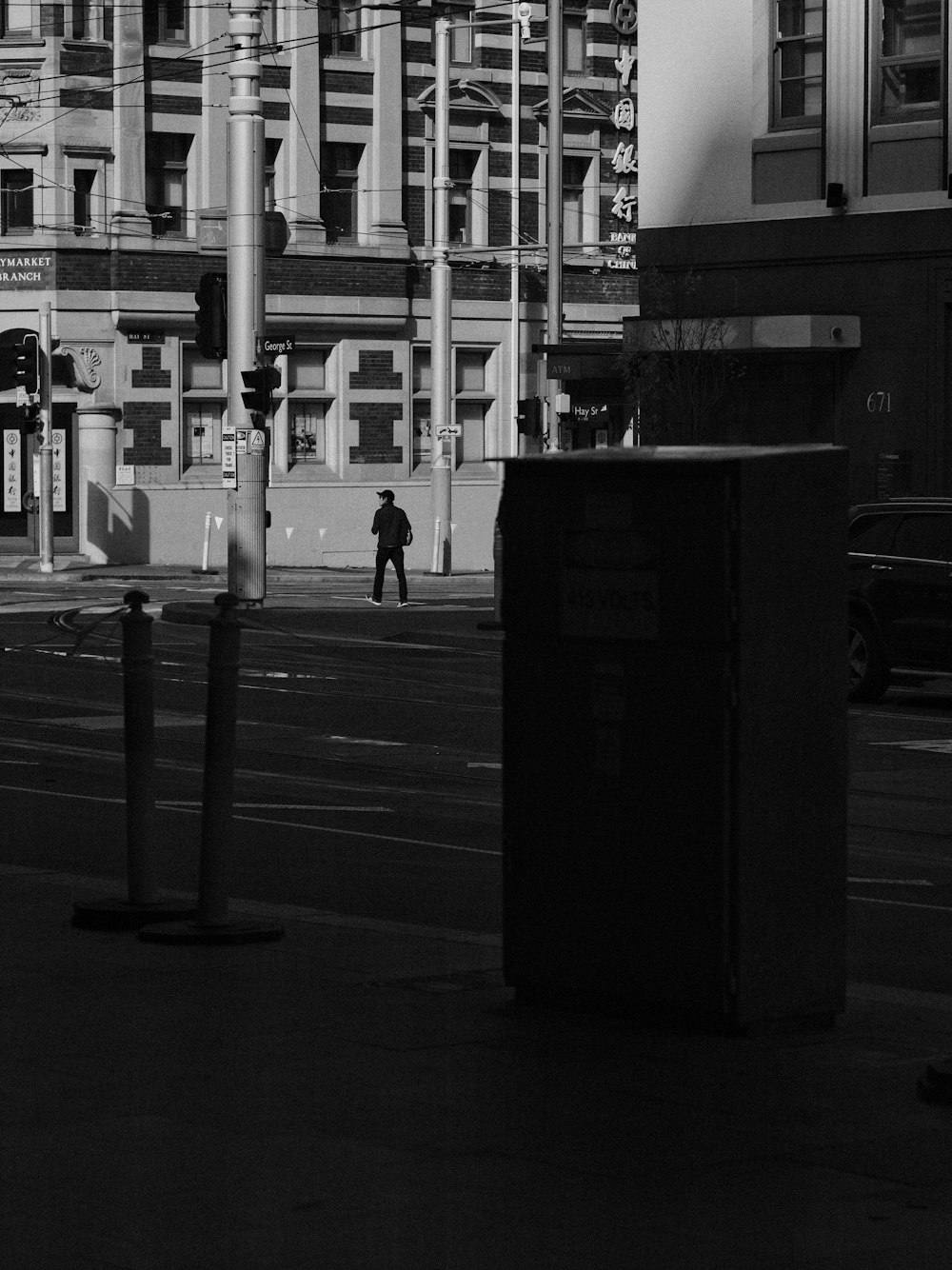 grayscale photography of person walking on road