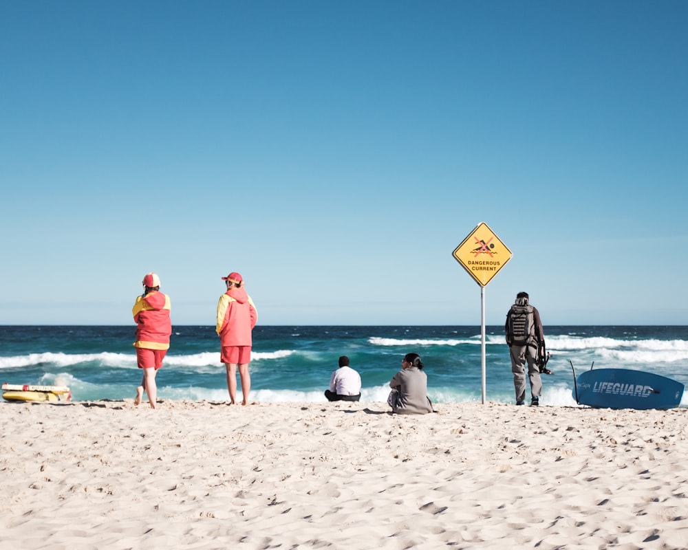 five person on seashore