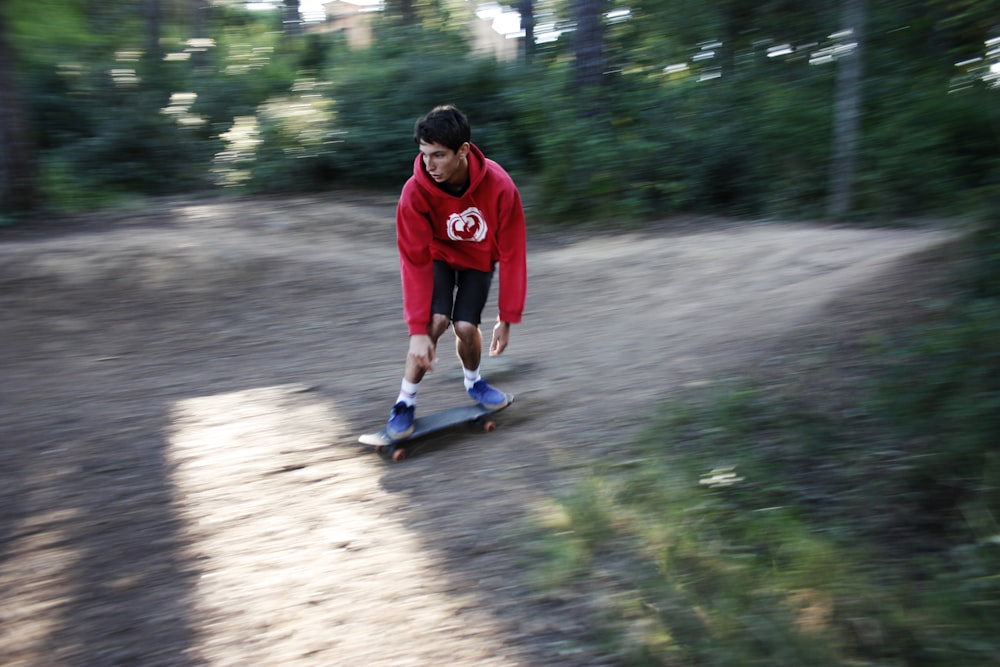 man in red hoodie skate boarding