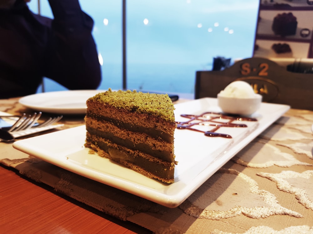 chocolate cake slice on rectangular white plate