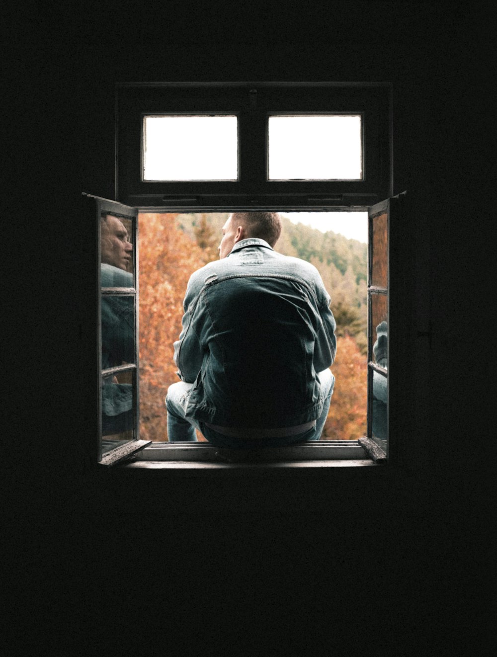 man siting on window