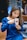woman wearing blue dress holding white mug