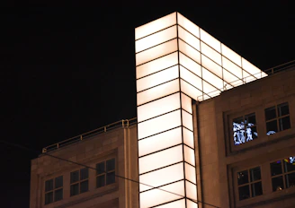 Illuminated commercial building exterior showcasing modern lighting design at dusk.