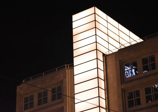 Illuminated commercial building exterior showcasing modern lighting design at dusk.