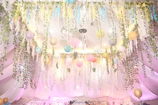 Custom decorations including hand-crafted signage and delicate hanging lanterns creating a dreamy atmosphere.