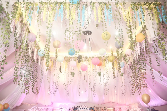 Custom decorations including hand-crafted signage and delicate hanging lanterns creating a dreamy atmosphere.