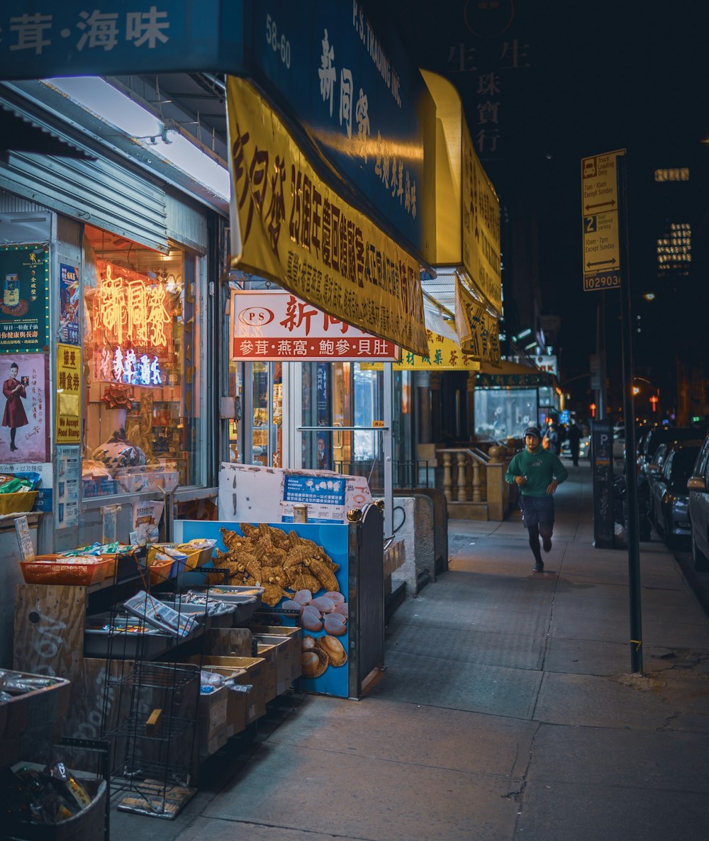 man running near store during nighttime