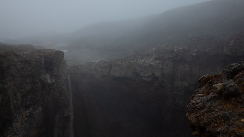 a foggy day at a canyon in the mountains