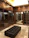 A cozy, custom wooden walk-in closet with warm lighting and elegant storage solutions.