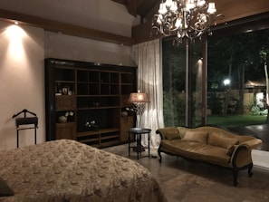 A spacious suite featuring elegant furnishings and natural light.