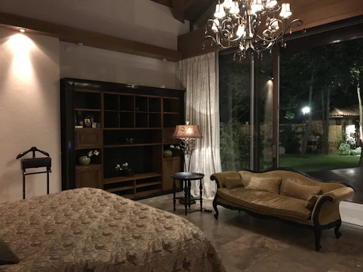 Cozy and romantic room with soft pink lighting and elegant decor highlighting the jacuzzi area.