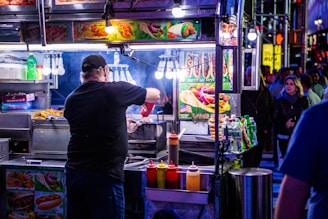 A vendor preparing delicious street food in a lively market setting.