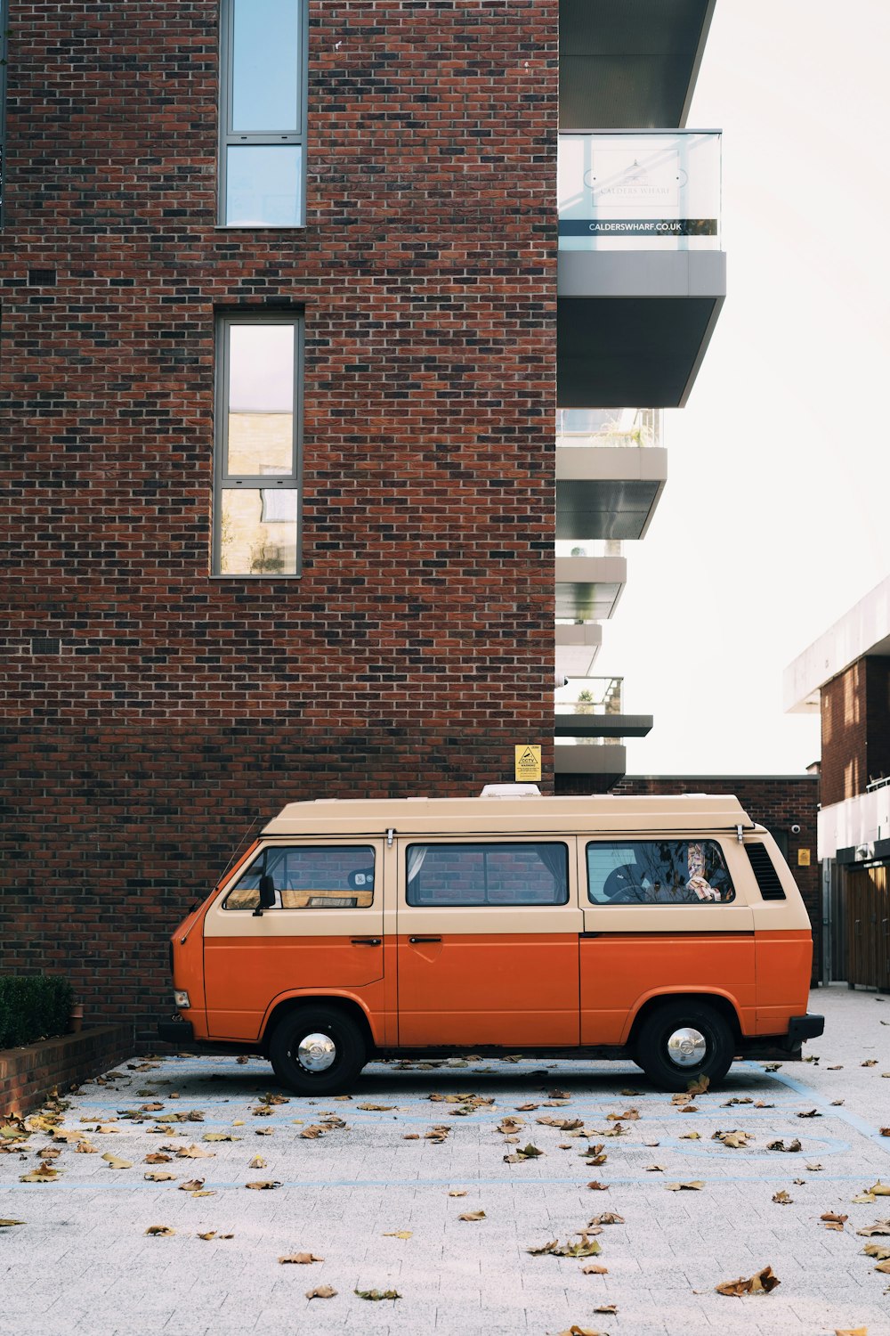 orange van parked beside building
