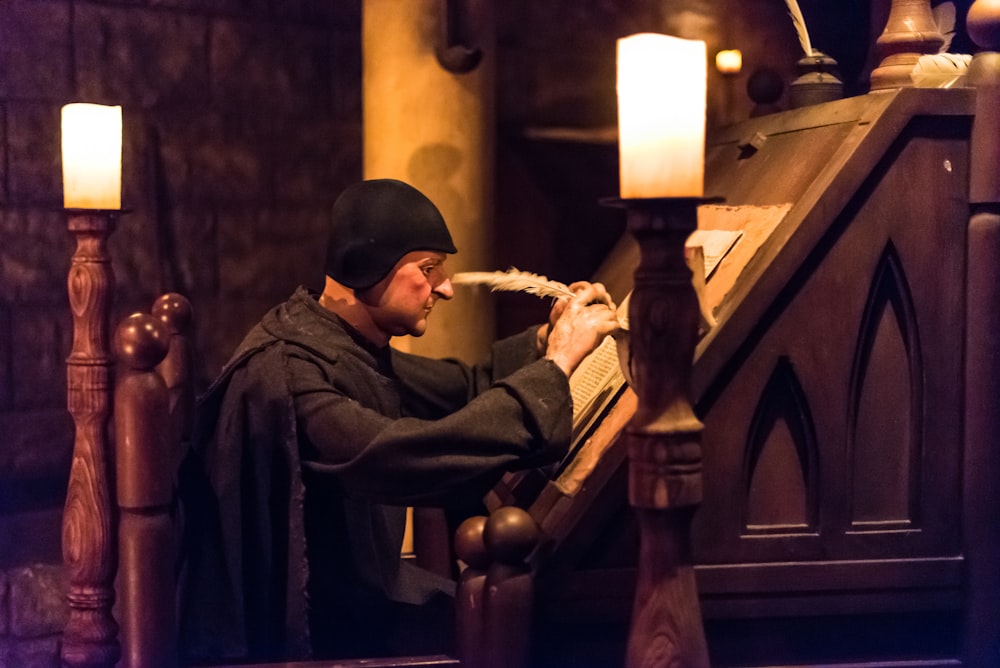 man writing on book