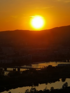 Sunset view over the river beside Riverdale Luxury Retreat with hills in the background