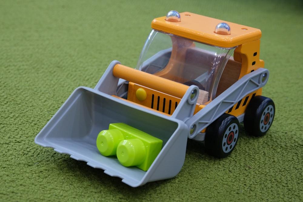 yellow and gray front loader toy