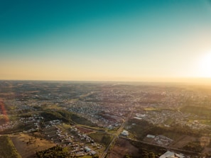An aerial shot taken by a lunexon drone showing a sprawling cityscape under a clear blue sky.