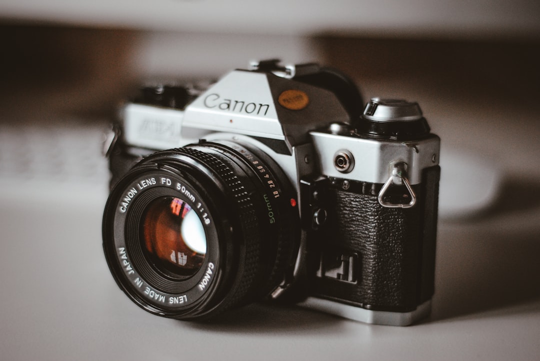 grey and black Canon SLR camera