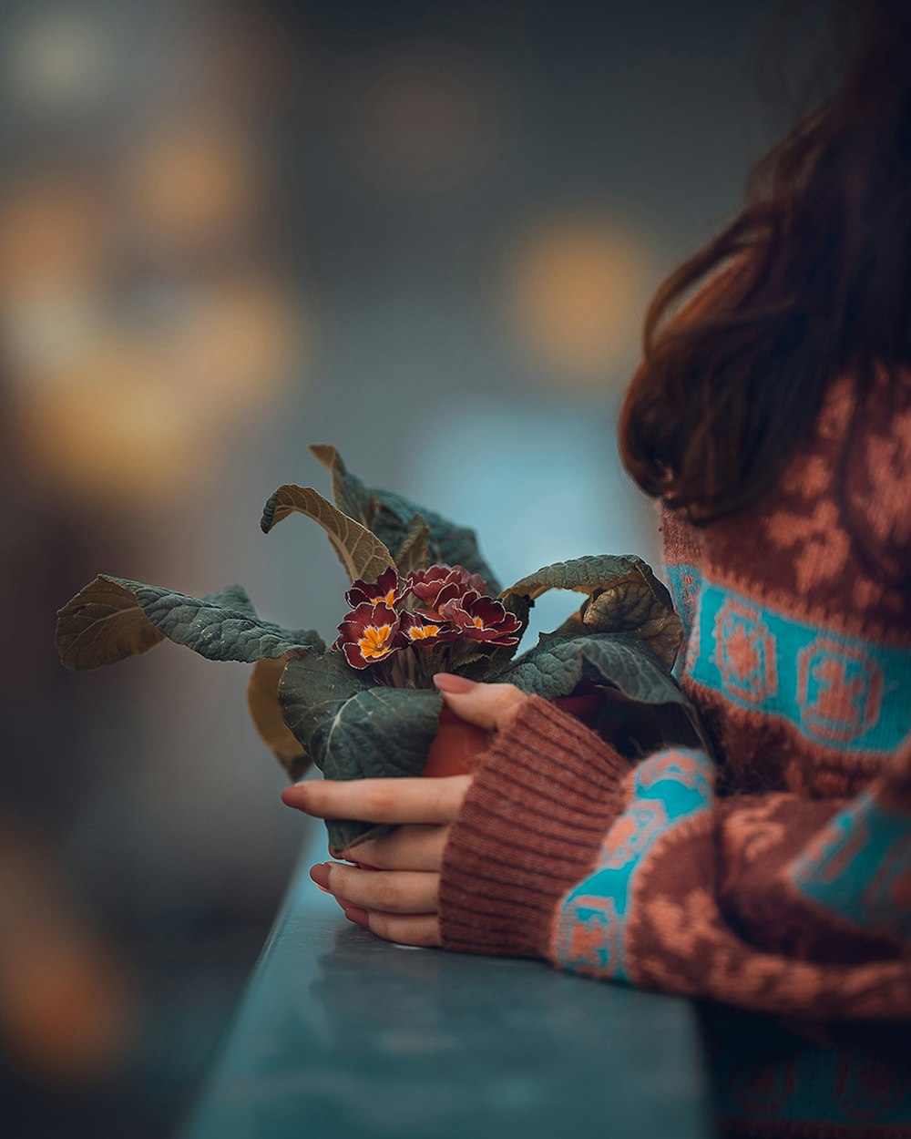 a woman holding a flower in her hands