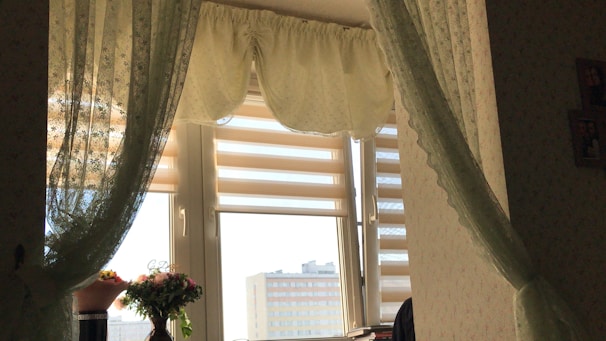 Short window valance hanging gracefully over a sunlit kitchen window