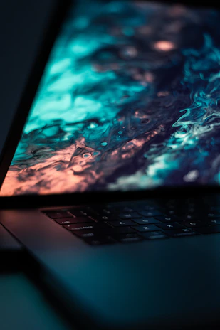 Close-up of a laptop keyboard with benchmark scores visible on the screen in a clean, geometric style.