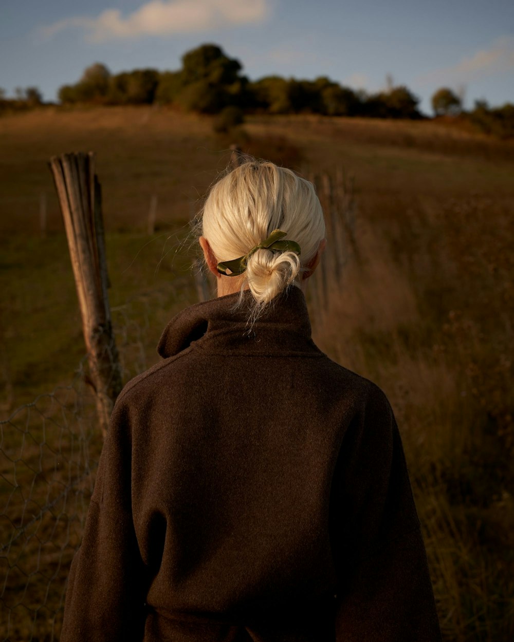 woman standing on brown field