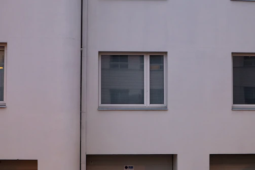 Exterior view of a building facade freshly renovated with smooth plaster and clean lines.