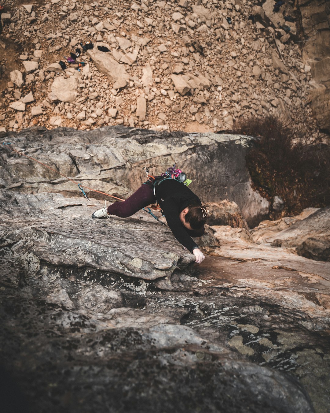 woman doing wall climbing at the cliff