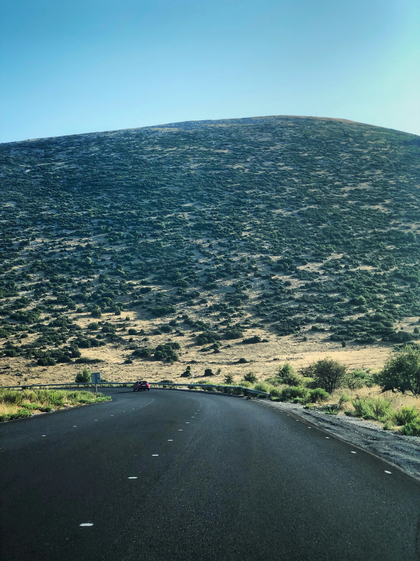 Open road through dry hills near Erythres in Greece