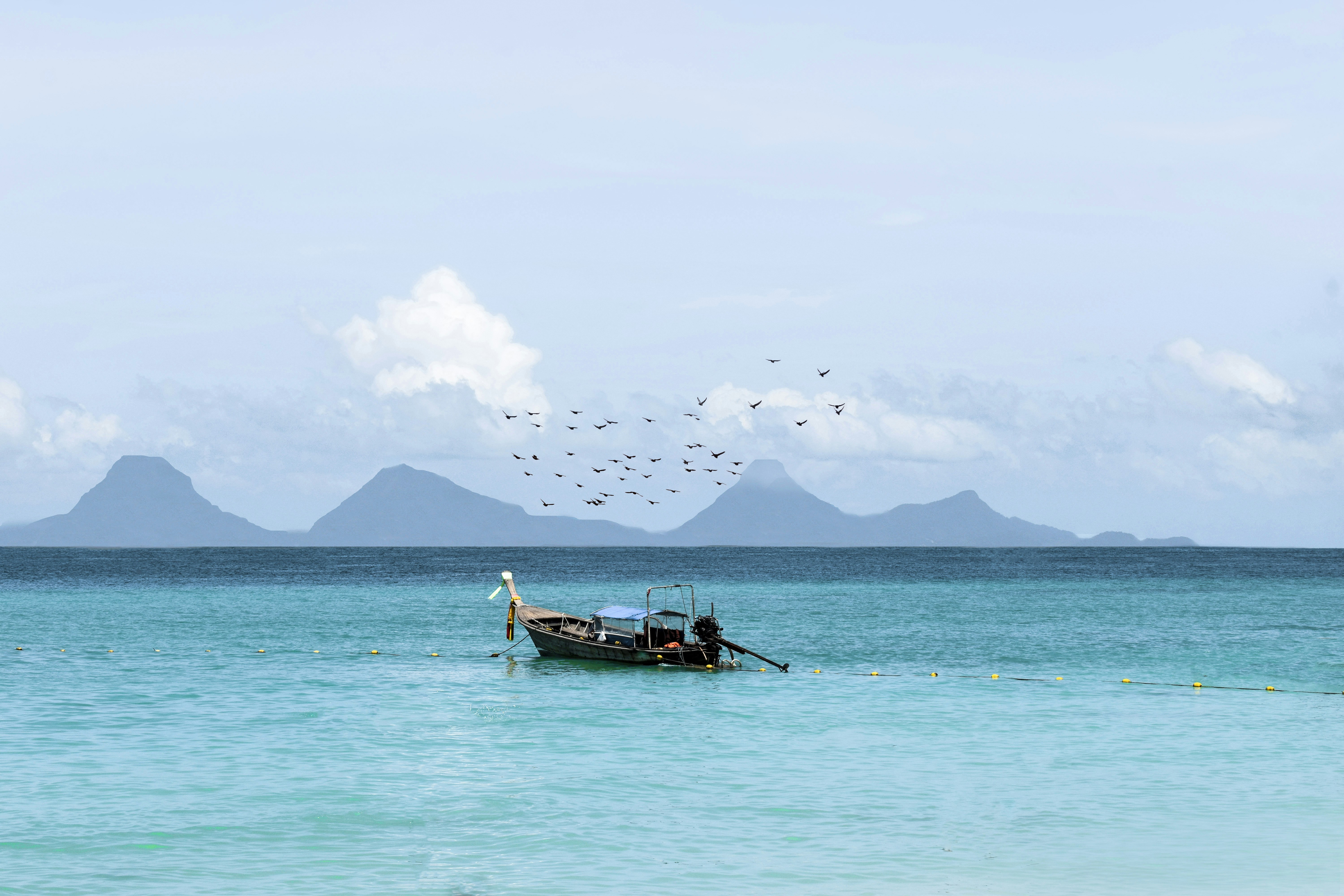 brown wooden boat on body of water during daytime