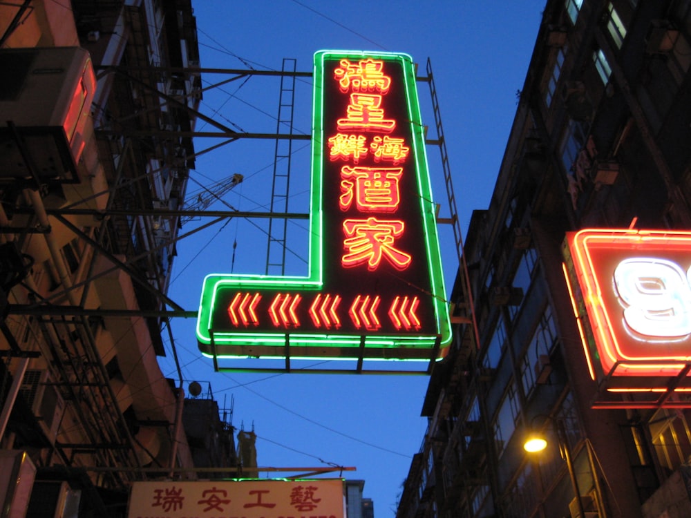 orange, black, and green neon signage