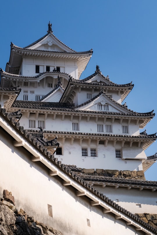 white and gray pagoda temple in Himeji Castle Japan