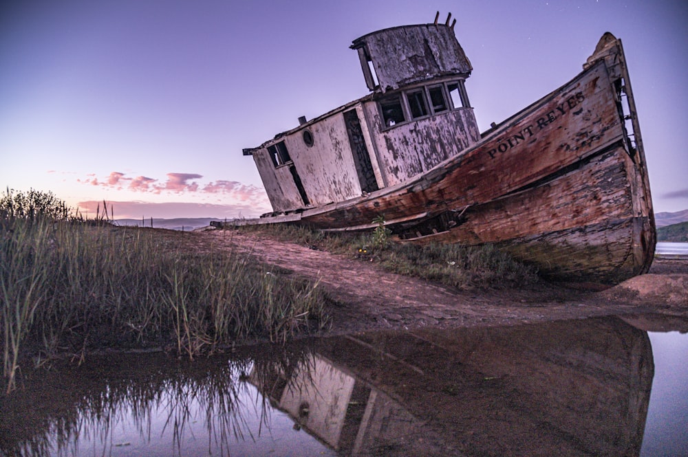 brown boat on grass field