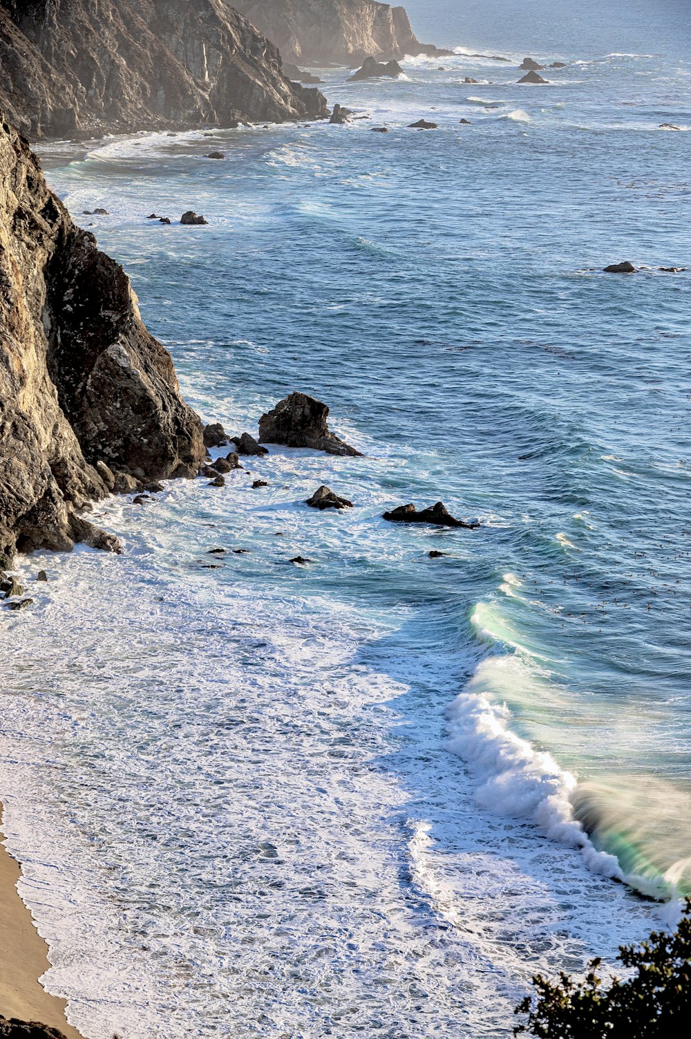 beach line beside cliff