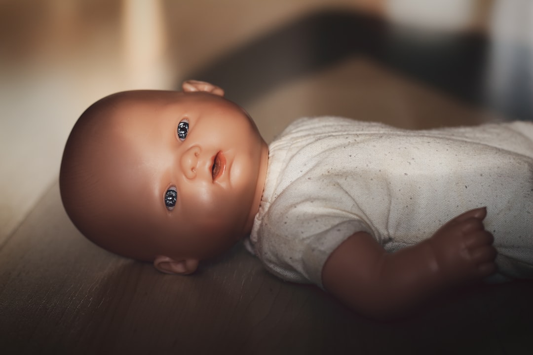 baby doll on wooden floor