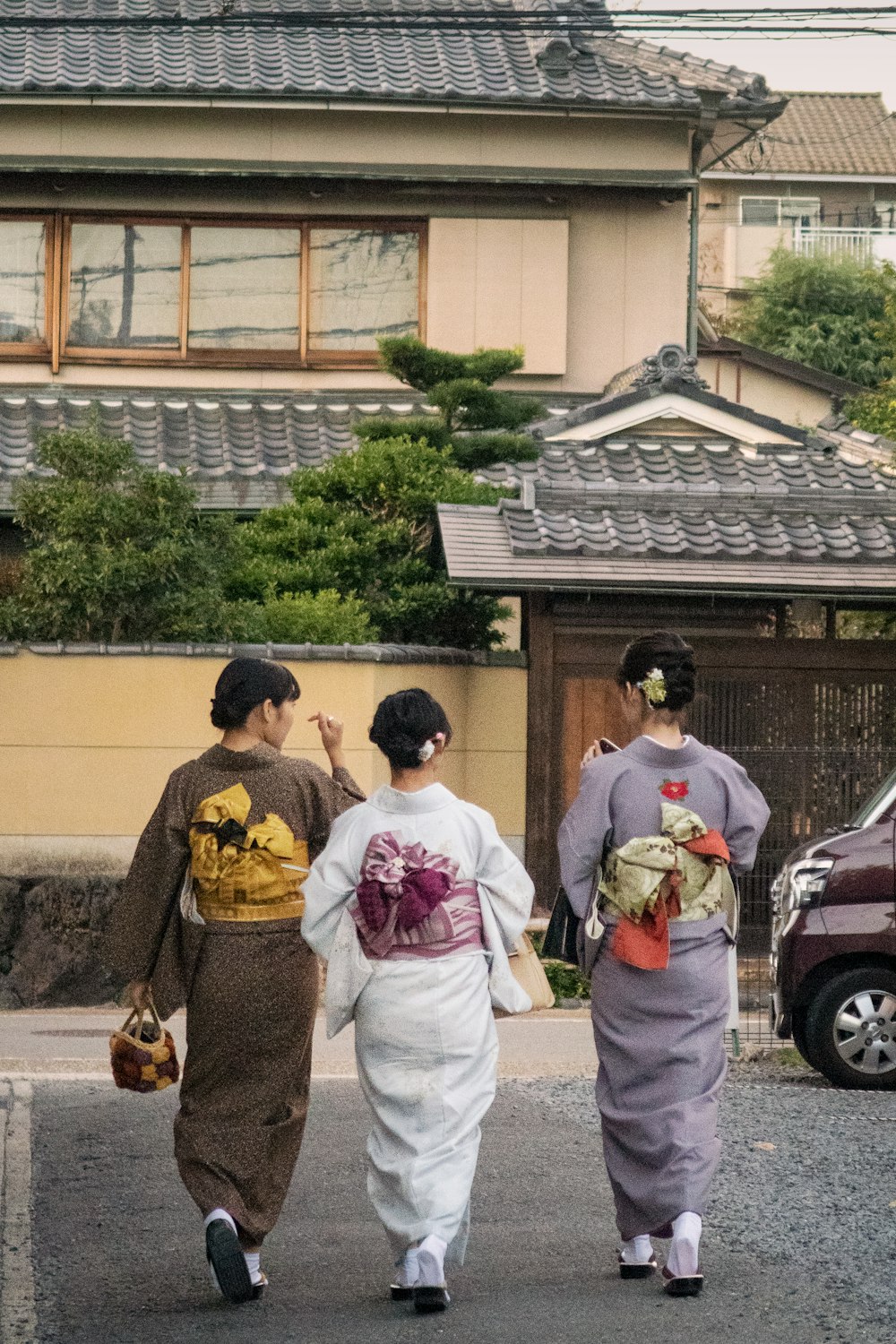 three women walking on paved raod