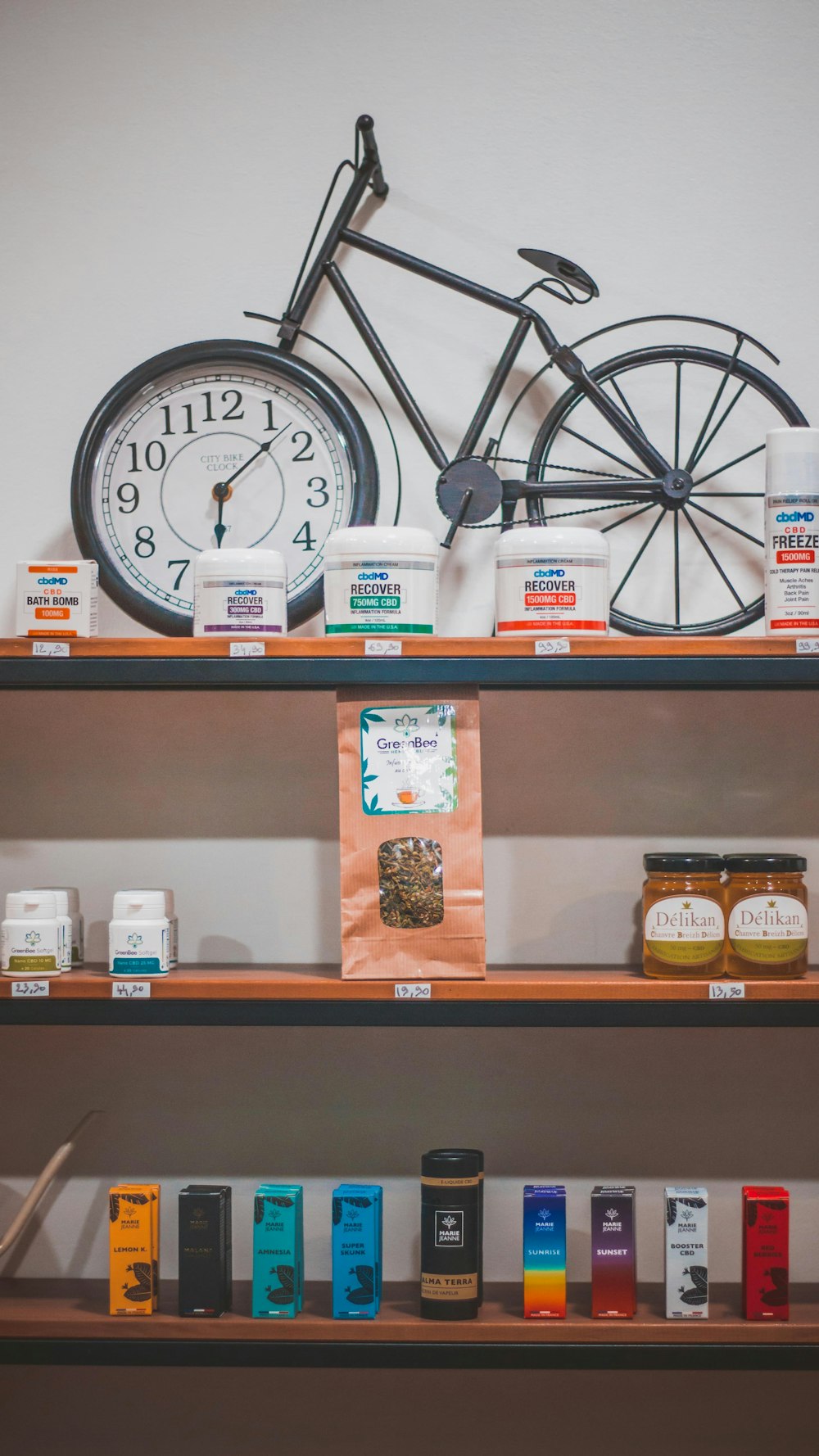 black bicycle analog clock on shelf