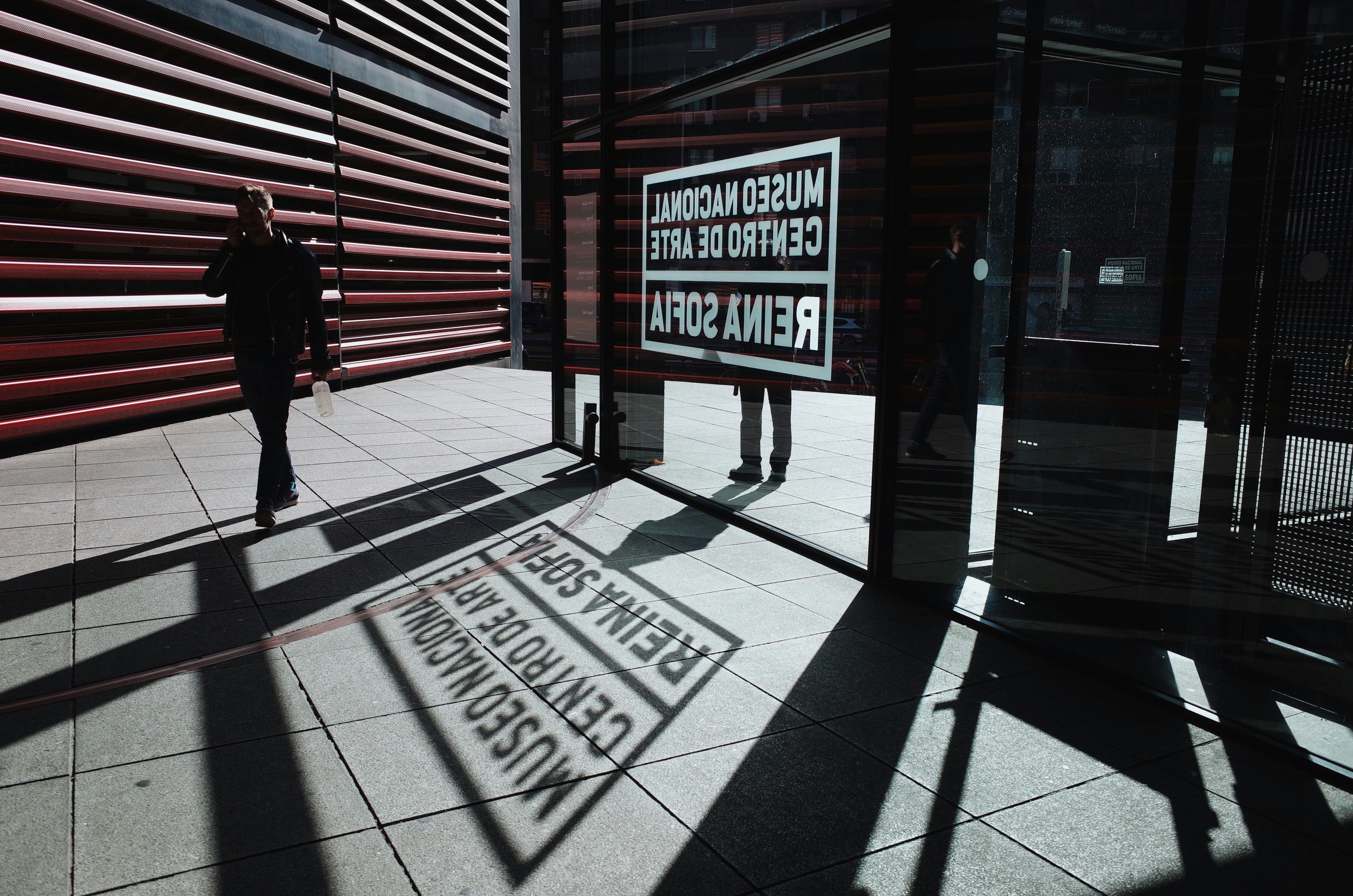 person walking beside wall