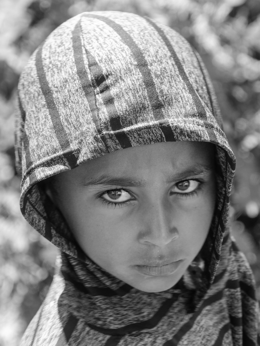 a young boy wearing a hat and scarf