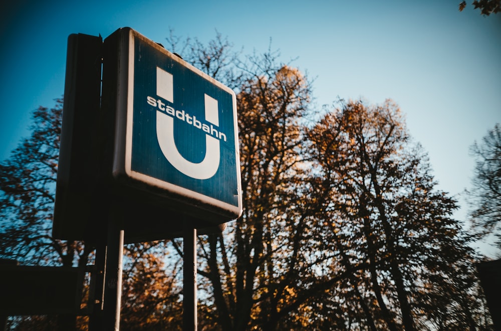 trees beside blue Stadtbahn signage