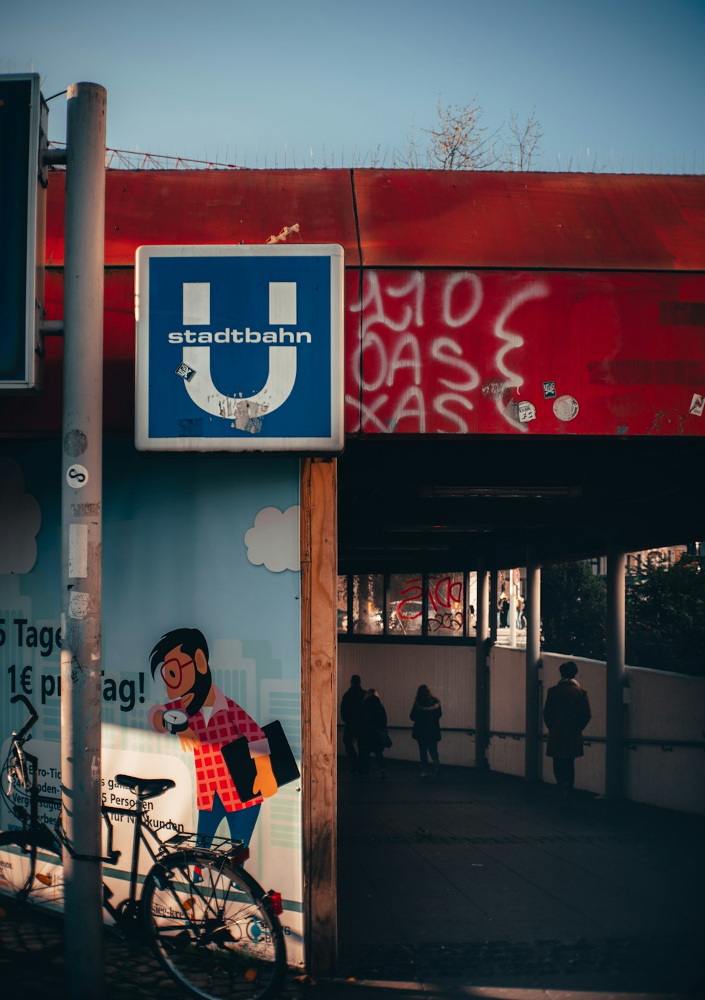 a bike parked in front of a blue u sign