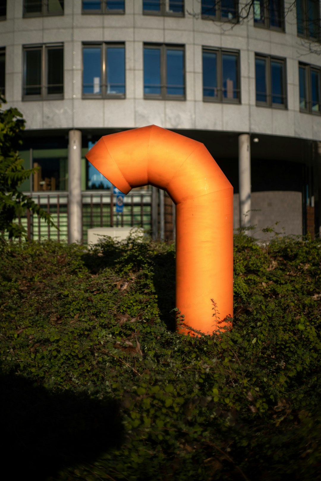 orange metal pipe and gray concrete building