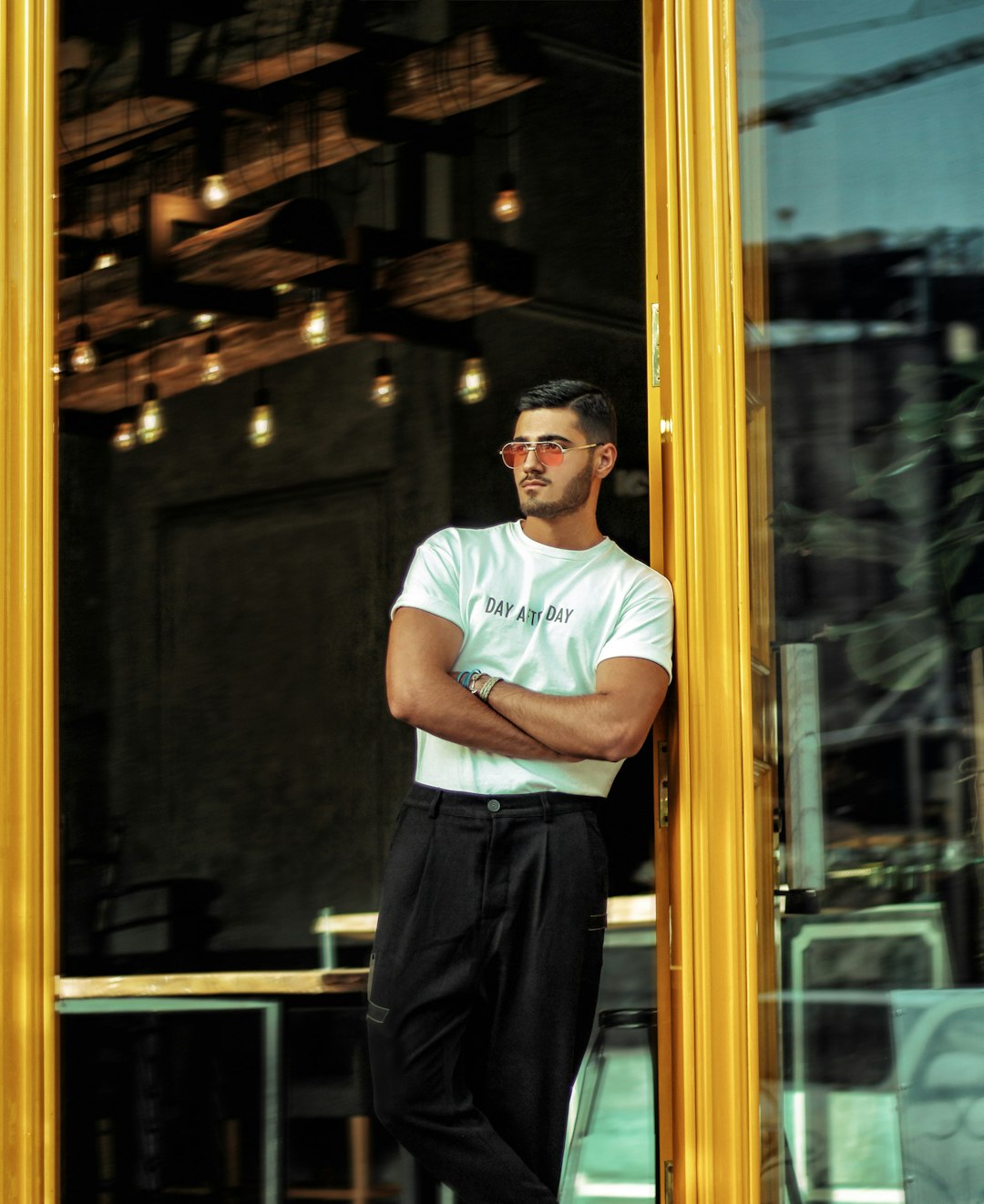 man wearing white crew-neck shirt and black pants