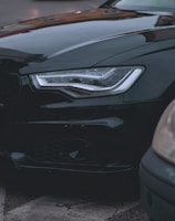 Close-up of a sleek car advertisement billboard on a busy urban street.