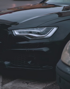 Close-up of a sleek car advertisement billboard on a busy urban street.
