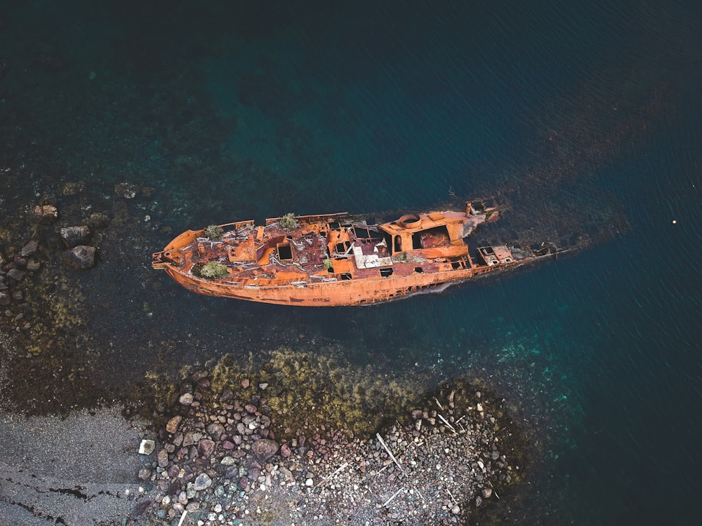 an old rusted boat in a body of water