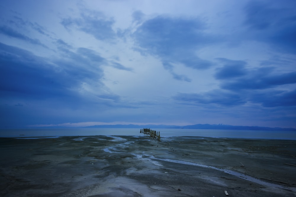 body of water under blue sky