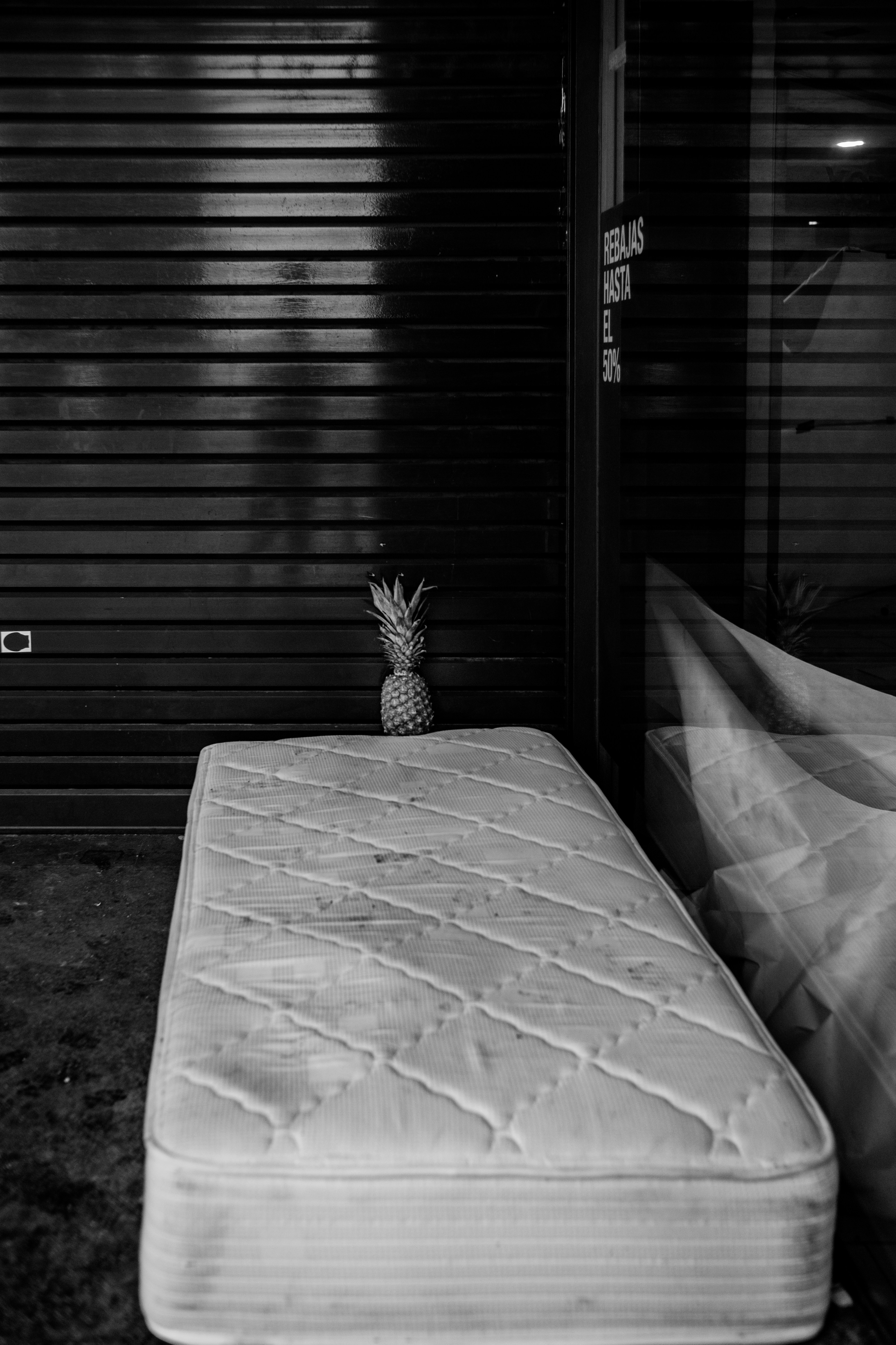 grayscale photography of ottoman beside mirror